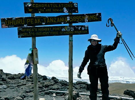 Lobbyist Jody Richardson celebrates the top of Uhuru, the highest peak of Kilimanjaro in Tanzania.