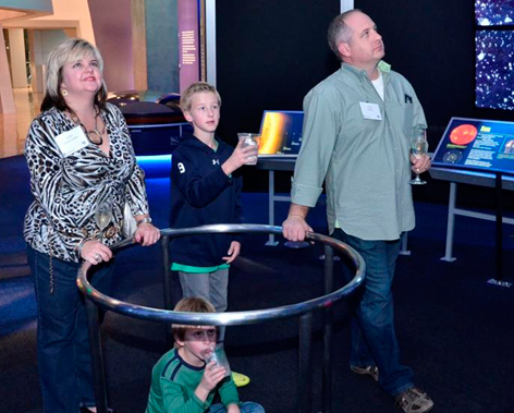 Linda Griffith (U.S. Trust), Jason Griffith and their two sons, Brendan and Joe, enjoy an exhibit at the Perot Museum