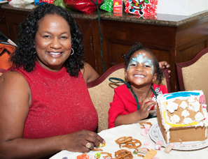 Kimberly Murphy and her daughter Emily putting the finishing touches on their gingerbread house.