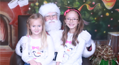 Audrey Briggs, left, goddaughter of Jackson Walker partner Mary Lou Flynn-DuPart, and her sister, Gracie Briggs, had their photo taken with Santa at the firm’s Breakfast With Santa event in Houston.