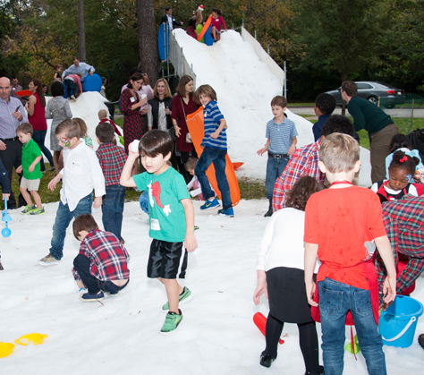 Families enjoy the “snow” at V&E’s annual Gingerbread party, held at the Houstonian.