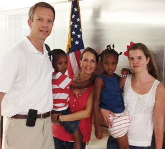 Cliff, Ayse and Olivia Vrielink arrive home from Haiti with Ashley and Bethiana in July 2014.